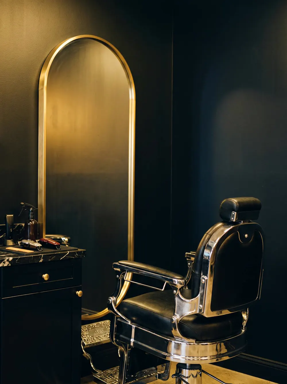 A barber's station with the chair and tools laid out